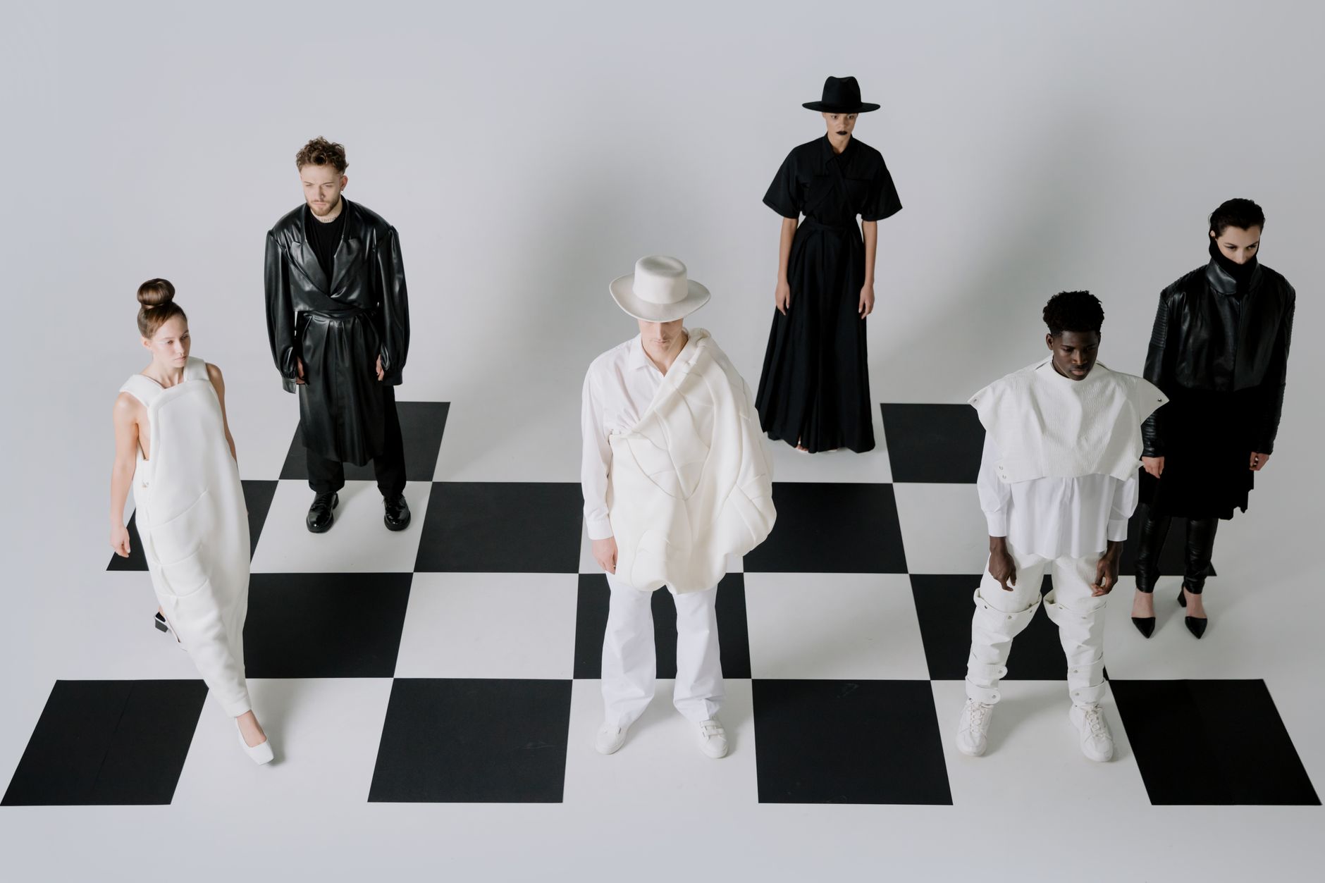 Stylish fashion models in black and white outfits on a chessboard backdrop. — Make your Lifestyle More Efficient With The 6th