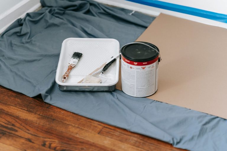 A collection of painting tools and materials prepared for a home renovation project indoors. — Need for Getting Professional