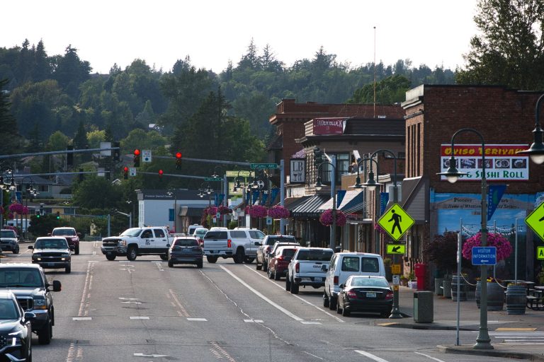 Lively urban street with cars, shops, and pedestrians during daytime. — Preserving Memories Forever: The Magic of an Audio Gu