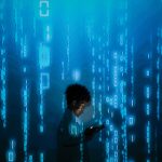 Silhouette of a person using a smartphone surrounded by digital binary code projections. — Pro Tips That You Should Know Befo