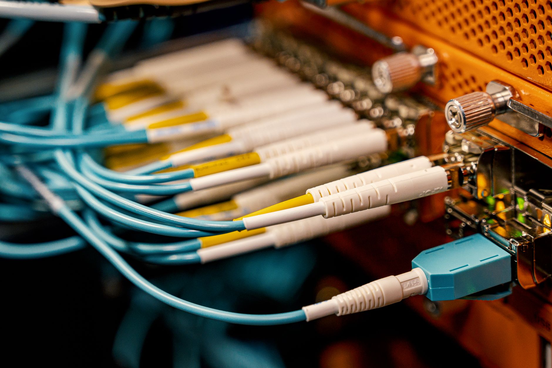From above of optical switch equipment with many similar connectors with rubber cables and metal parts — Read this to know if