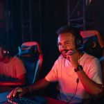 Two gamers immersed in an esports tournament, focused with headsets and keyboards. — Roulette Royale: Play Like Royalty at Ev