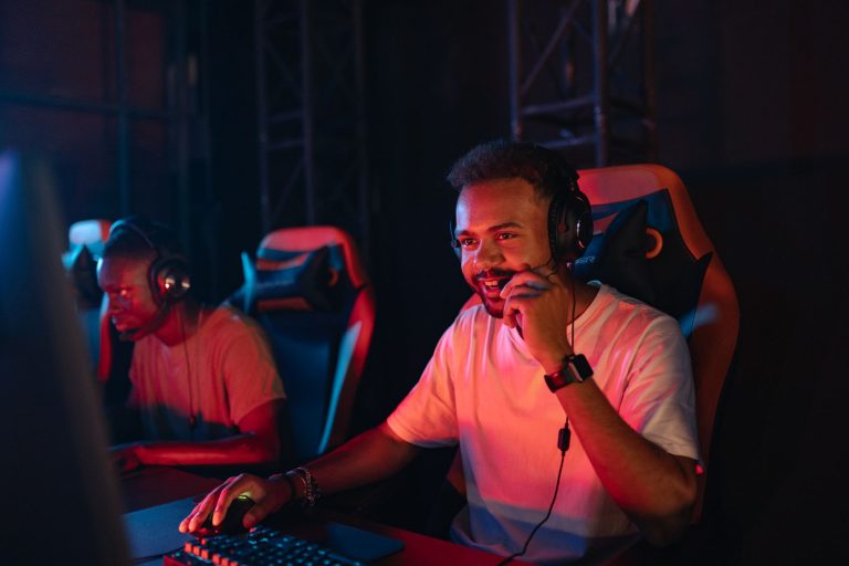 Two gamers immersed in an esports tournament, focused with headsets and keyboards. — Roulette Royale: Play Like Royalty at Ev
