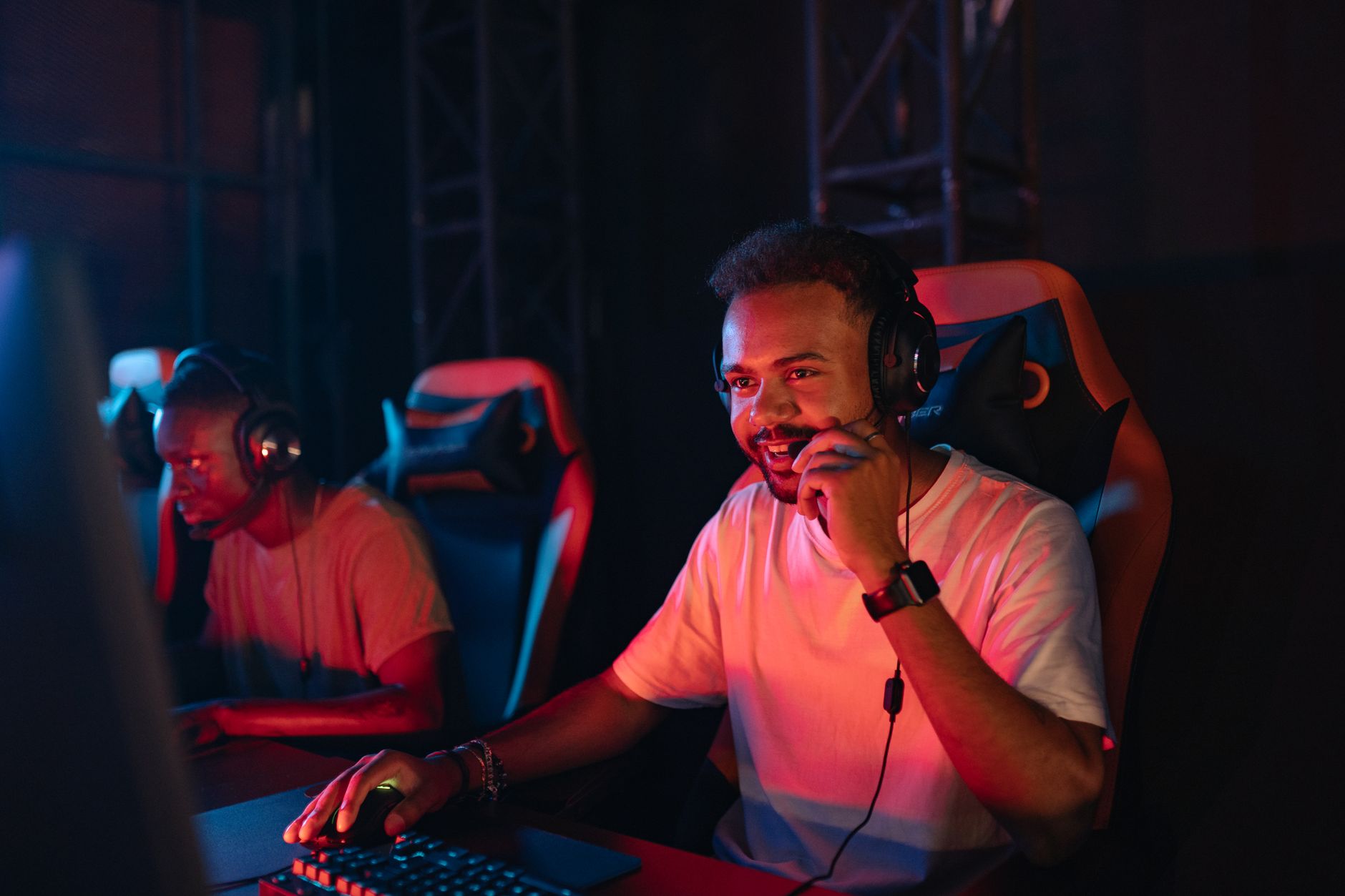 Two gamers immersed in an esports tournament, focused with headsets and keyboards. — Roulette Royale: Play Like Royalty at Ev