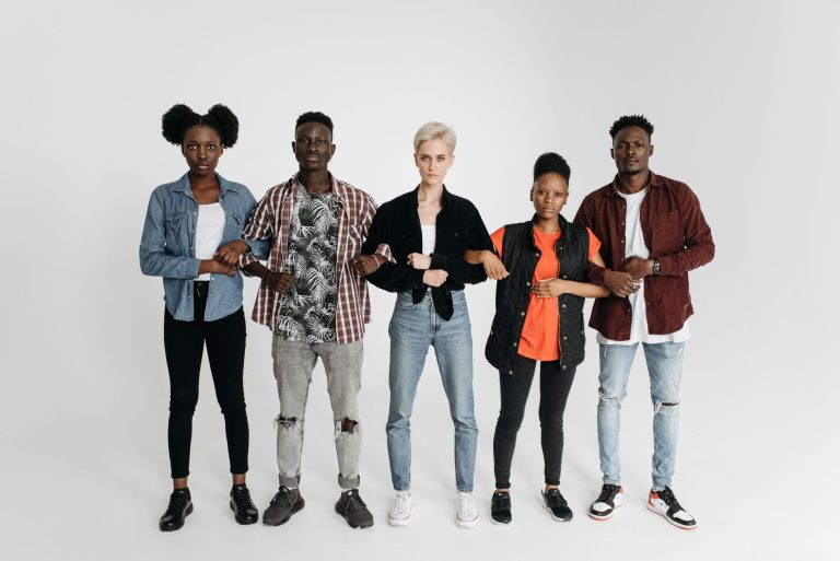 A diverse group of young adults united and holding hands, symbolizing solidarity and activism. — Say No to Ill-Fitted Sneaker