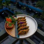 Delicious gourmet vegetable dish served on a balcony with an elegant presentation and a scenic outdoor background. — Seafood