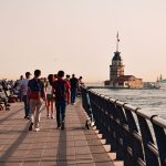 People walking along waterfront promenade in İstanbul with view of Maiden's Tower. — SIX best small towns to visit in Washing