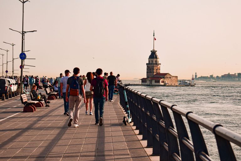People walking along waterfront promenade in İstanbul with view of Maiden's Tower. — SIX best small towns to visit in Washing