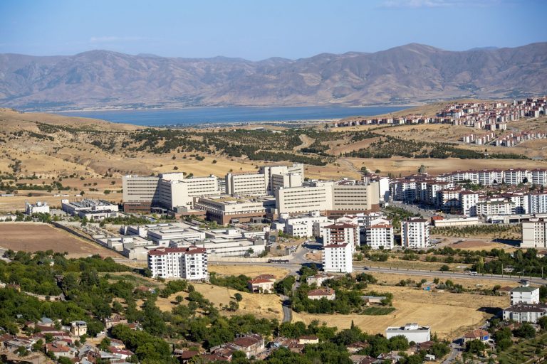 Stunning aerial photograph capturing the expansive cityscape of Elâzığ, Türkiye, with distant mountains. — Reconnecti