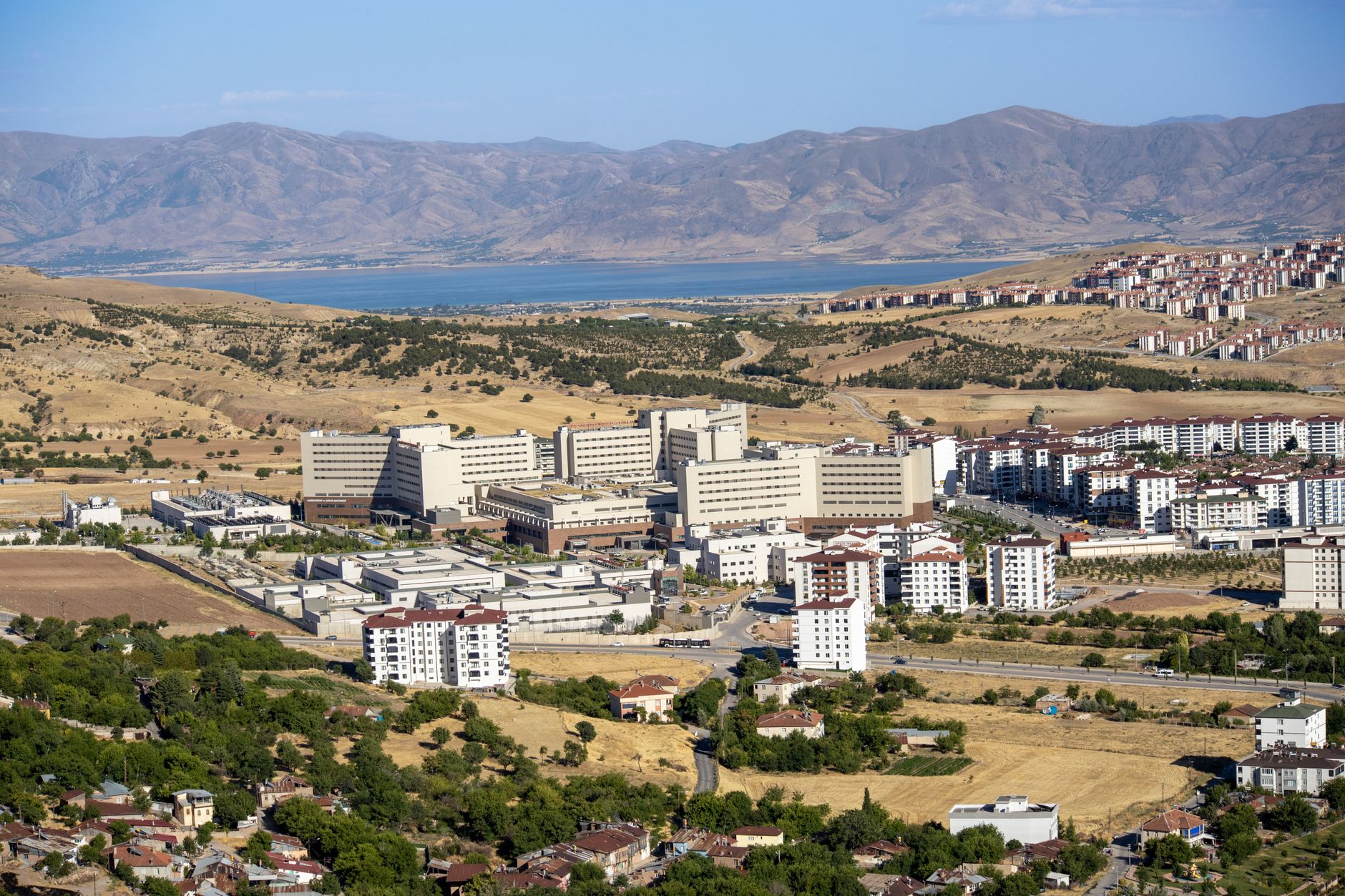 Stunning aerial photograph capturing the expansive cityscape of Elâzığ, Türkiye, with distant mountains. — Reconnecti