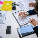 Team reviewing financial charts and digital data on tablets in an office setting. — The Exciting Reasons Why You Shou