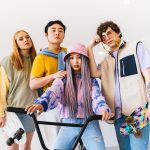 Four stylish friends posing with skateboards and a bicycle, showcasing modern fashion. — The 6 Tricks to Buy Cheap on Amazon