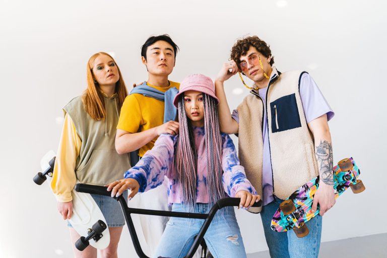 Four stylish friends posing with skateboards and a bicycle, showcasing modern fashion. — The 6 Tricks to Buy Cheap on Amazon