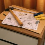 From above of wooden cabinet with drawers and paper instruction with tool to assemble it — The Benefits of Investing in Nora