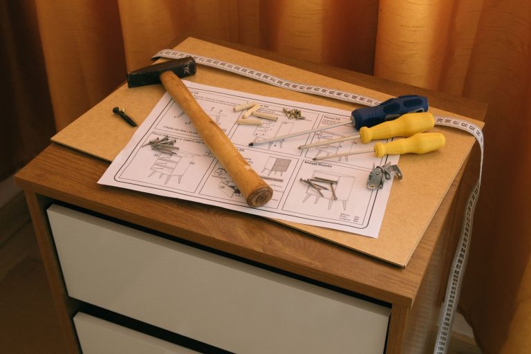 From above of wooden cabinet with drawers and paper instruction with tool to assemble it — The Benefits of Investing in Nora