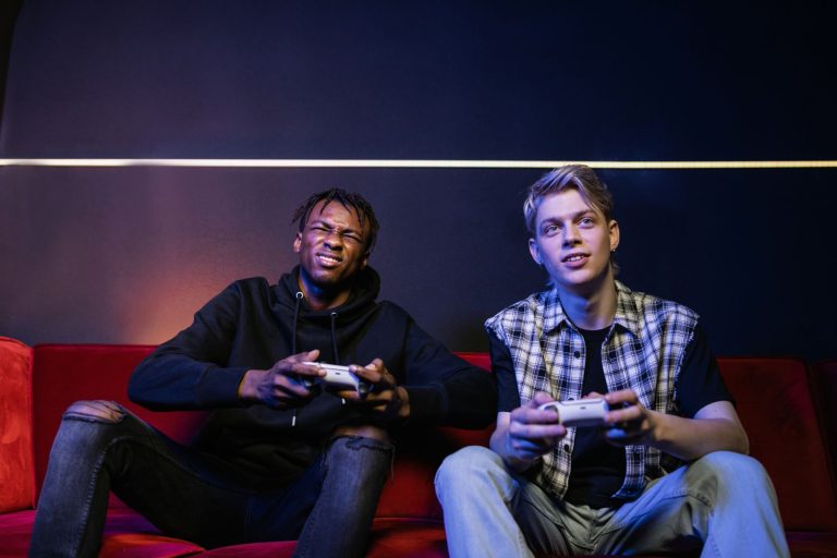 Two young men enjoying video games together on a couch, capturing leisure and friendship. — The Rise of Online Casino Gaming