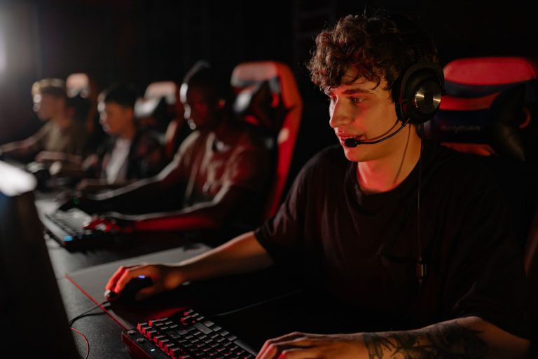 A dedicated team of young gamers engaging in a competitive esports tournament. — The rules and gameplay of Domino QQ revealed