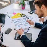 Business team reviewing graphs and data in an office setting. — The Tax Management Options That You Get