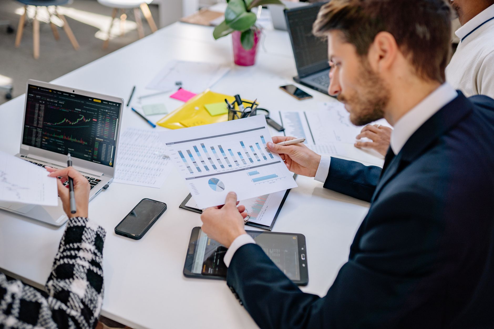 Business team reviewing graphs and data in an office setting. — The Tax Management Options That You Get