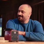 Casual portrait of a man in a blue sweater sitting indoors at a restaurant. — The Ultimate Guide To Sports Betting Online