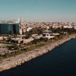 Aerial drone view of Istanbul's seaside cityscape featuring urban architecture and the Bosphorus shoreline. — Tipsoffered by