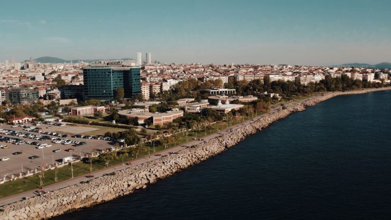 Aerial drone view of Istanbul's seaside cityscape featuring urban architecture and the Bosphorus shoreline. — Tipsoffered by
