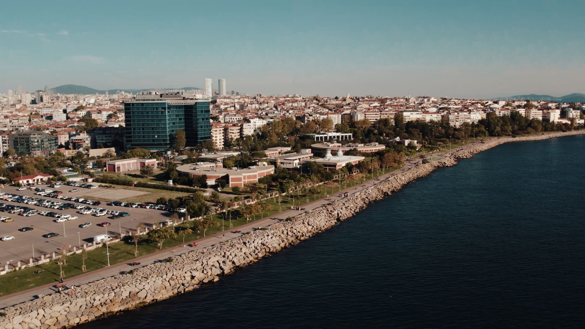Aerial drone view of Istanbul's seaside cityscape featuring urban architecture and the Bosphorus shoreline. — Tipsoffered by