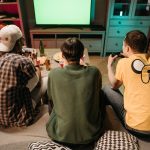 Three young men enjoying a home gaming session together, playing video games in a cozy indoors setting. — Try Your Luck and W