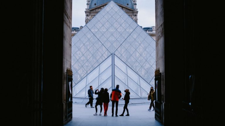 Tourists explore the stunning Louvre Pyramid in Paris, a famed architectural landmark. — Two-person fishing kayaks advantage