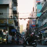 Colorful busy street scene in Cần Thơ, Vietnam with vibrant signs and people. — Types of basic security guards training