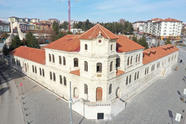 Aerial view of a historic stone building with red tile roofs in Sivas, Turkey, on a sunny day. — Understanding The Advantages