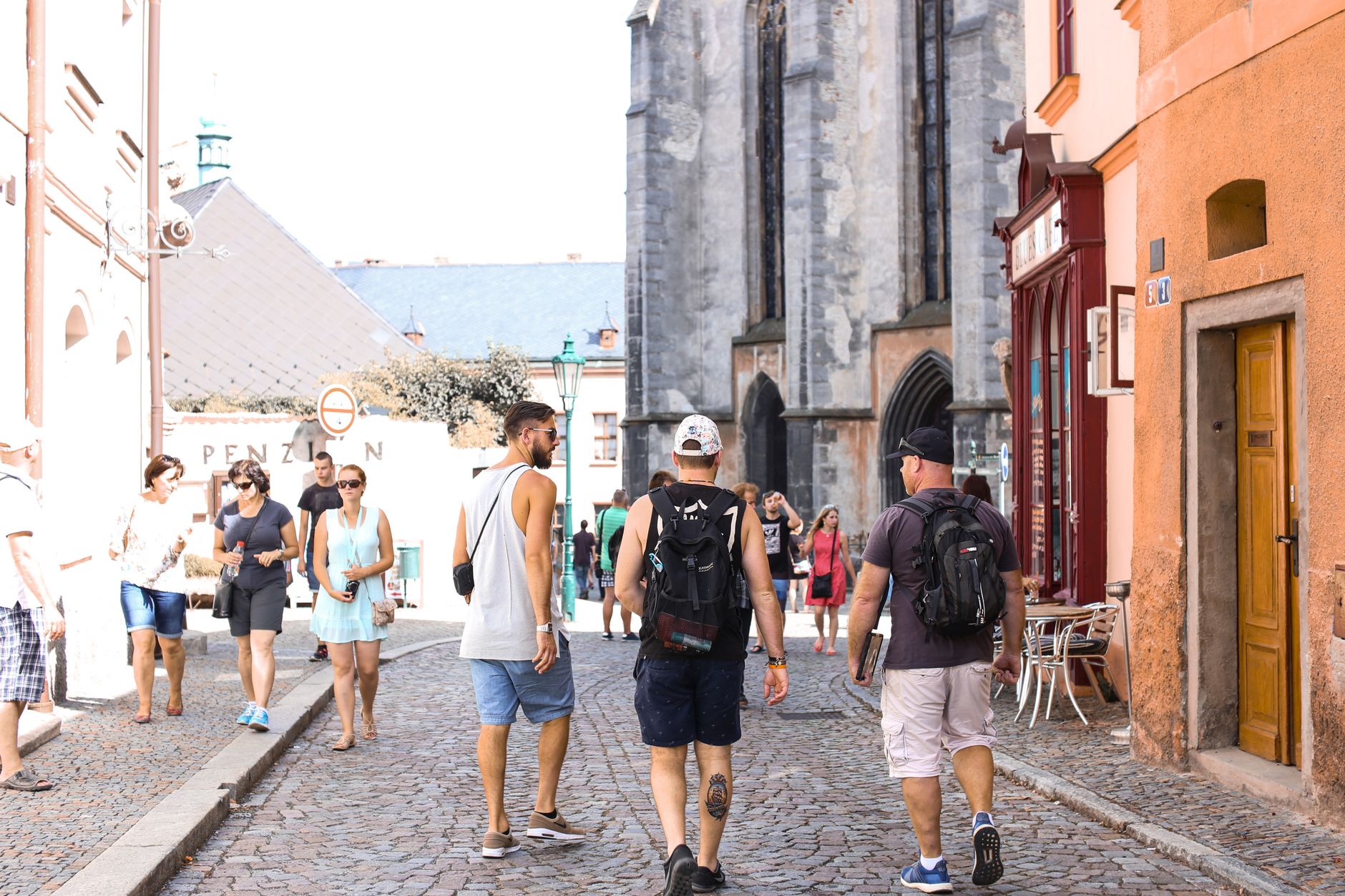 A bustling stone road in a historic European city filled with tourists enjoying a summer day. — Watch the Rare Japanese Anima