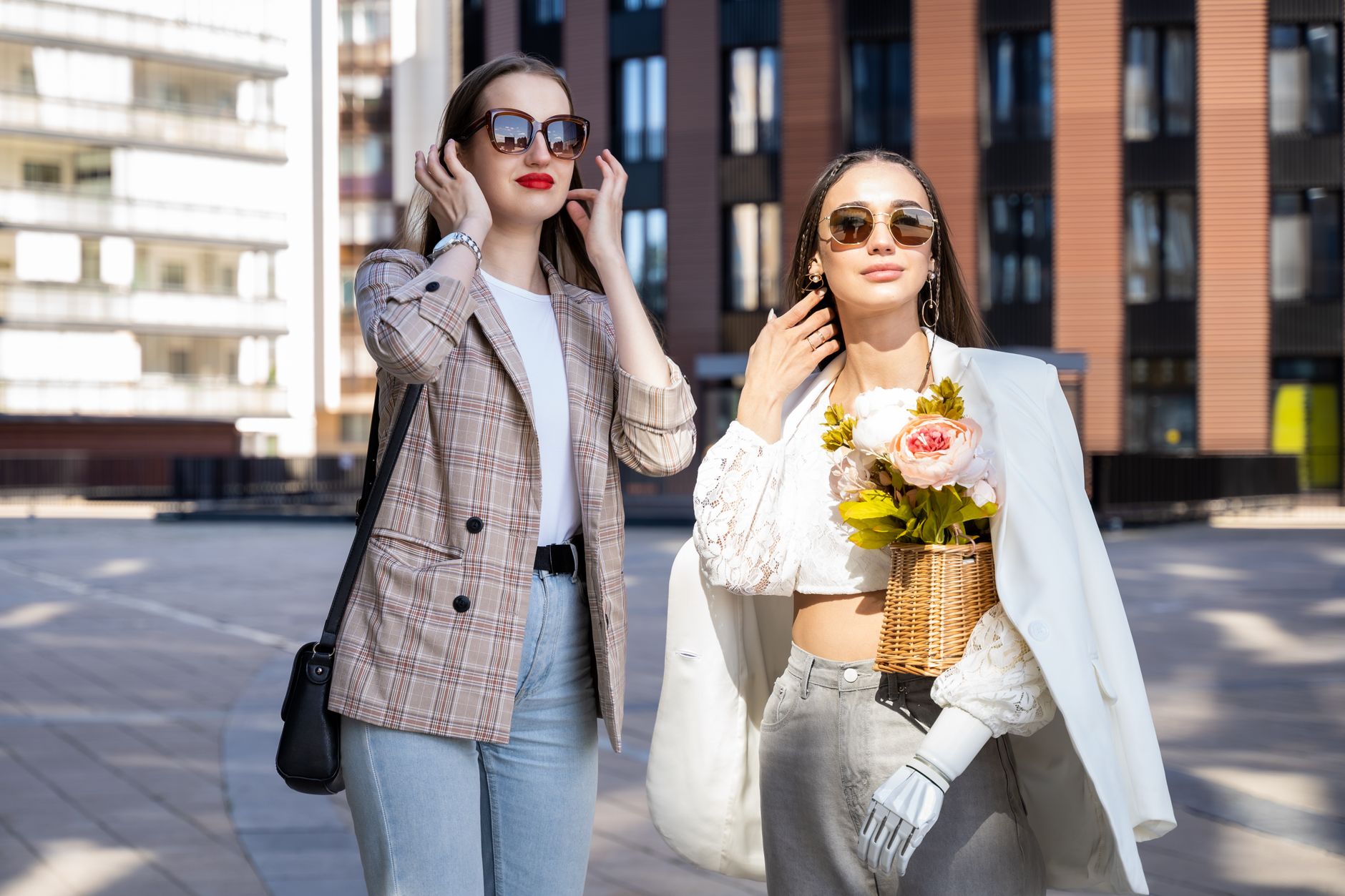 Two stylish women enjoy a sunny day in the city wearing chic outfits and sunglasses. — What do you mean by fingerprint jewelr