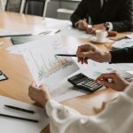 Professionals reviewing financial graphs and charts during a meeting. — What it's Like to Date a Madrid Whore