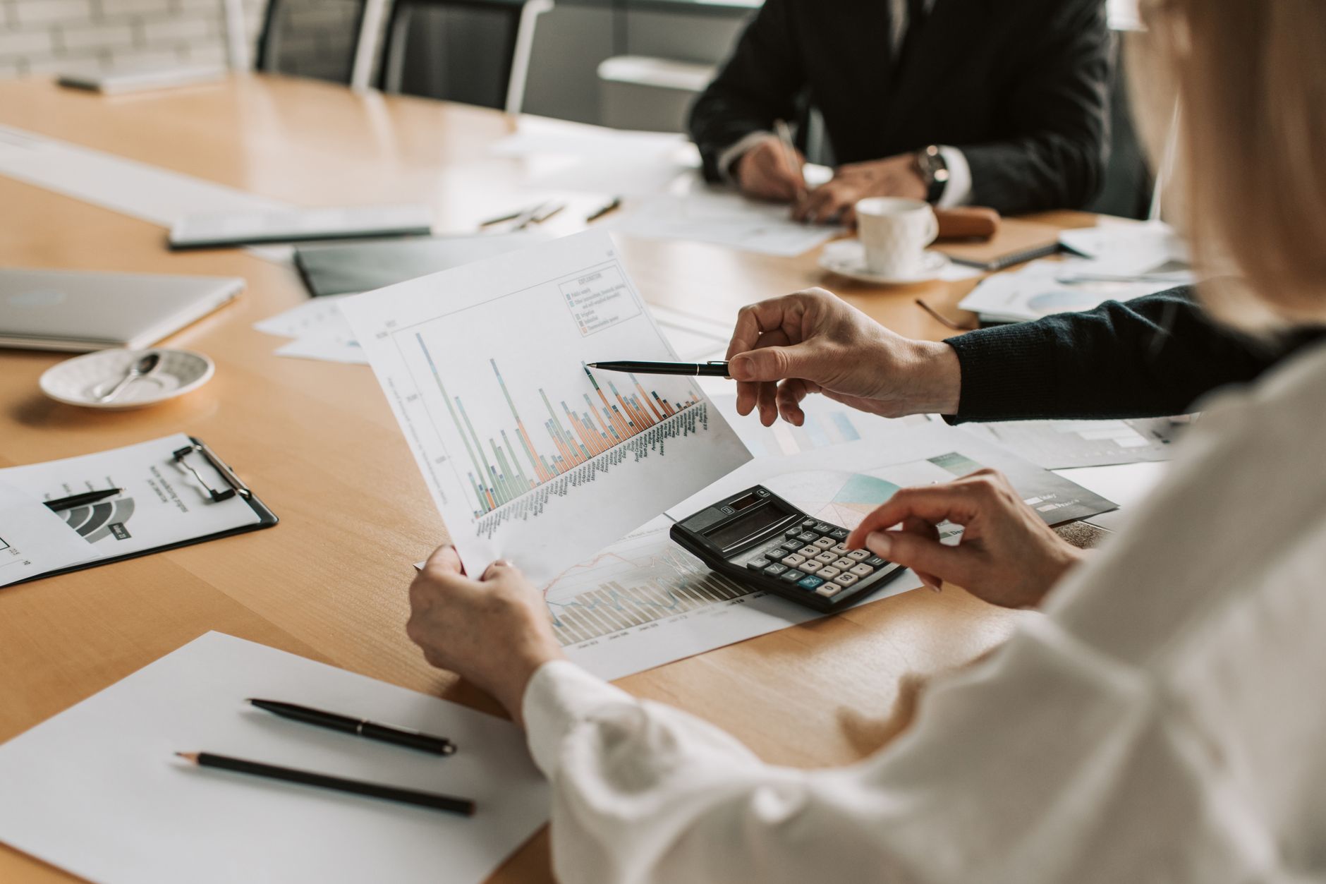 Professionals reviewing financial graphs and charts during a meeting. — What it's Like to Date a Madrid Whore