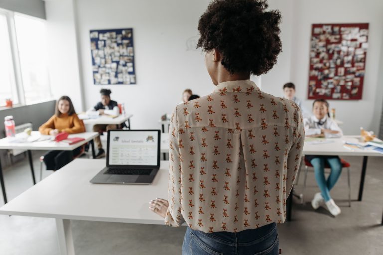 Female teacher engaging students in a classroom setting with diverse learners. — What Kind Of Courses Are Helpful In Getting