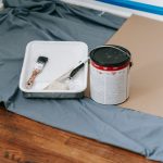A collection of painting tools and materials prepared for a home renovation project indoors. — What should you understand pri