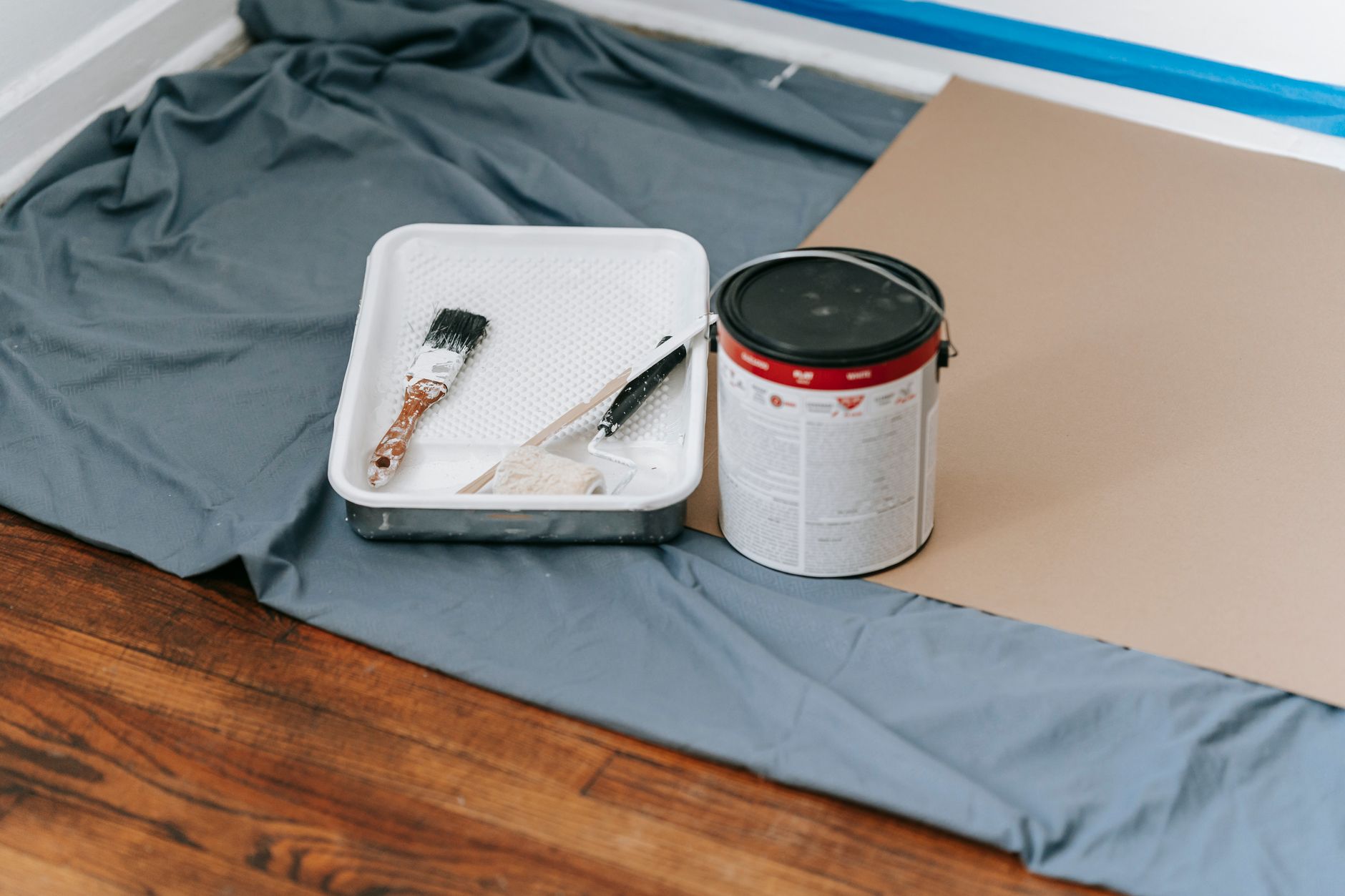 A collection of painting tools and materials prepared for a home renovation project indoors. — What should you understand pri
