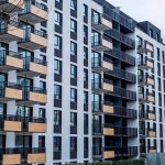 Contemporary apartment building with balconies in urban setting, showcasing modern architecture. — Why renting a Cost Effect