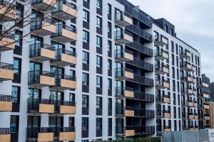 Contemporary apartment building with balconies in urban setting, showcasing modern architecture. — Why renting a Cost Effect