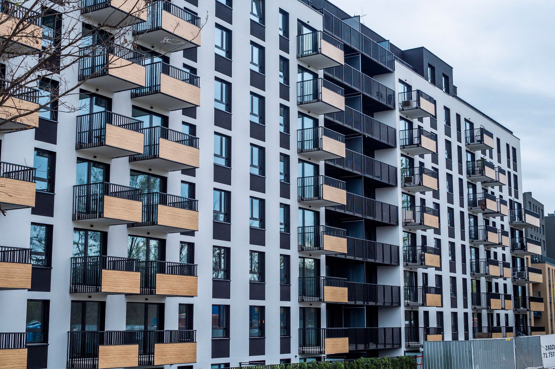 Contemporary apartment building with balconies in urban setting, showcasing modern architecture. — Why renting a Cost Effect