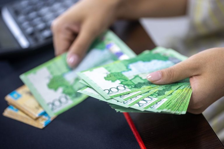 Person counting stacks of Uzbekistani som banknotes, showcasing financial transactions. — Why should you consider joining a f