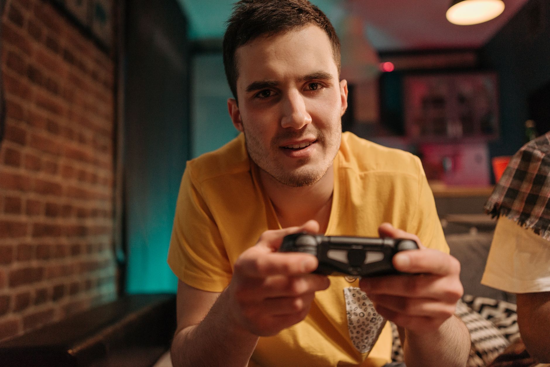 Focused young man enjoying video games with a controller indoors. — Why The Casimba Online casino Canada Is One OfThe MostPop