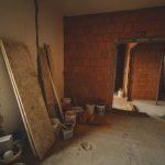 A red brick wall under construction with tools and materials scattered around in a renovation project. — WHY TIGER AND LEOPAR