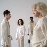 Explore diversity and style in this modern studio shoot featuring four adults in neutral outfits. — Why uniforms are an integ