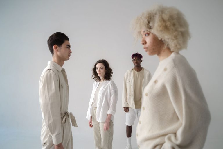 Explore diversity and style in this modern studio shoot featuring four adults in neutral outfits. — Why uniforms are an integ