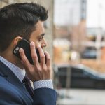 Professional man in suit making a phone call outside in city setting. — Why White Label SEO is the Best Way to Get Your Busin