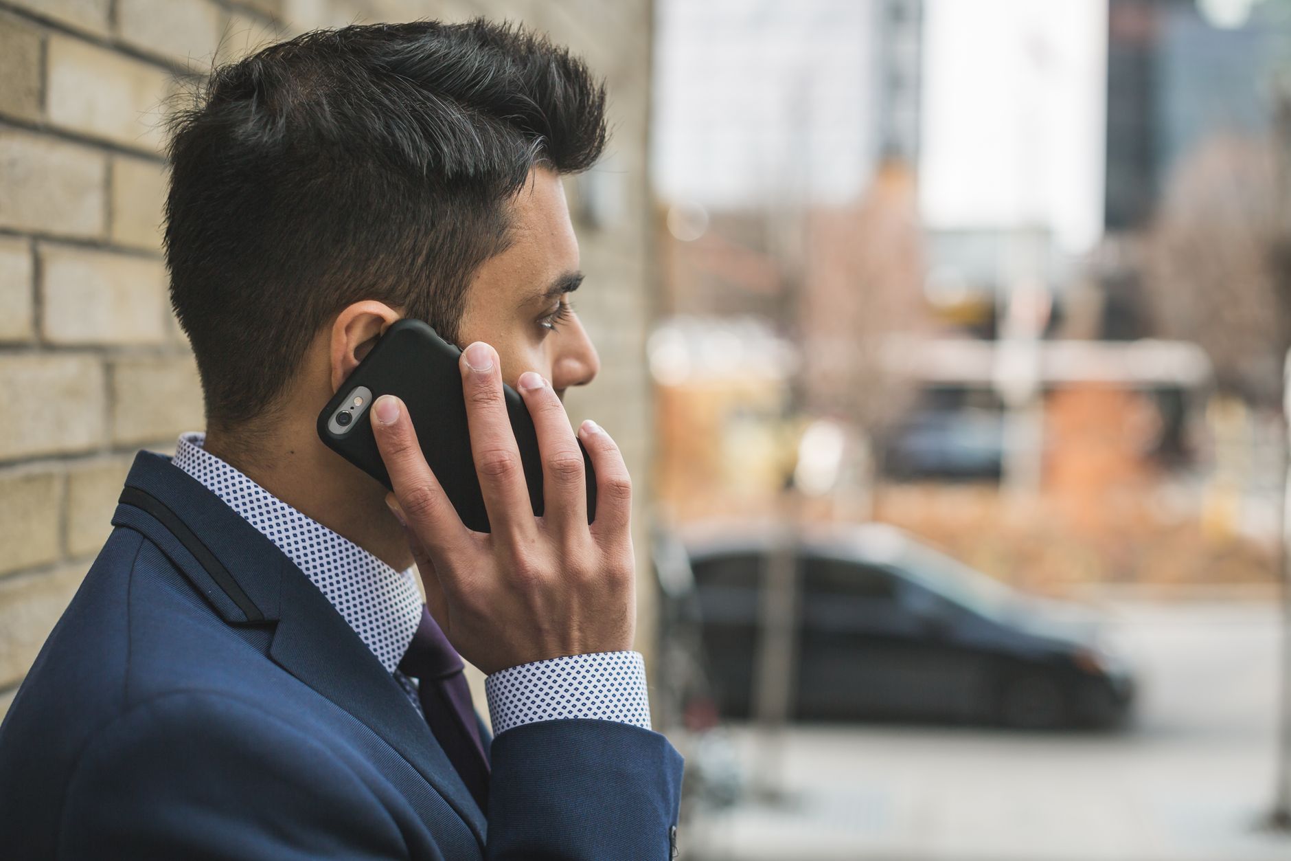 Professional man in suit making a phone call outside in city setting. — Why White Label SEO is the Best Way to Get Your Busin