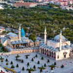 Vibrant aerial view of the iconic Mevlana Museum located in Konya, Türkiye, surrounded by lush greenery. — Your Love Life Is